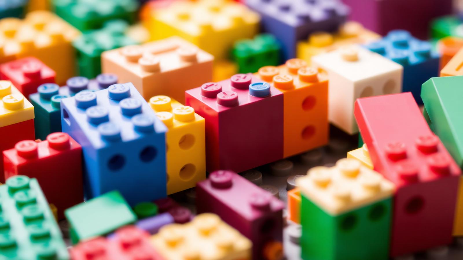 Modular brick architecture model on a baseplate showing layered levels and connected modules