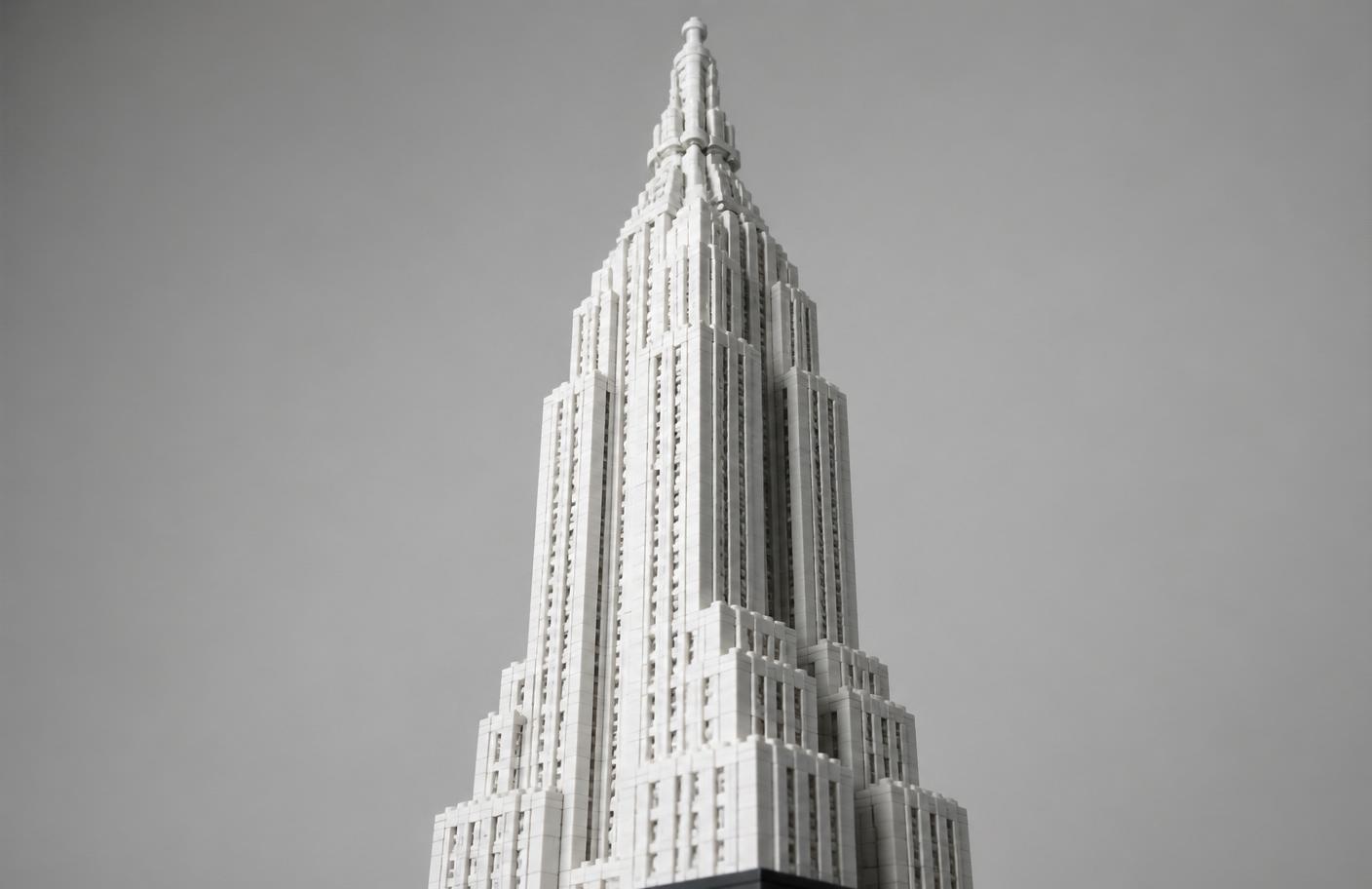 White monochrome brick skyscraper model with stepped setbacks and a stacked crown silhouette